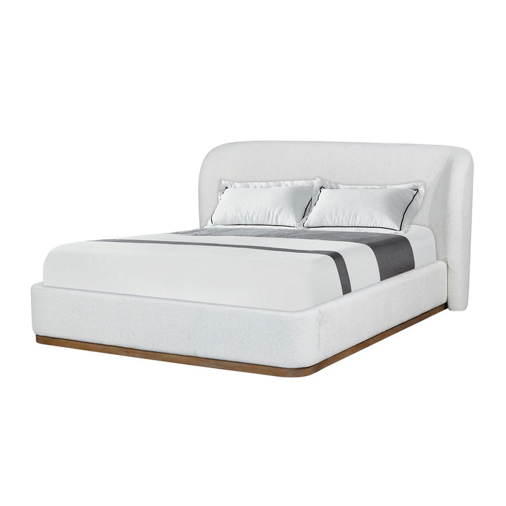White upholstered bed with wooden base on a white background