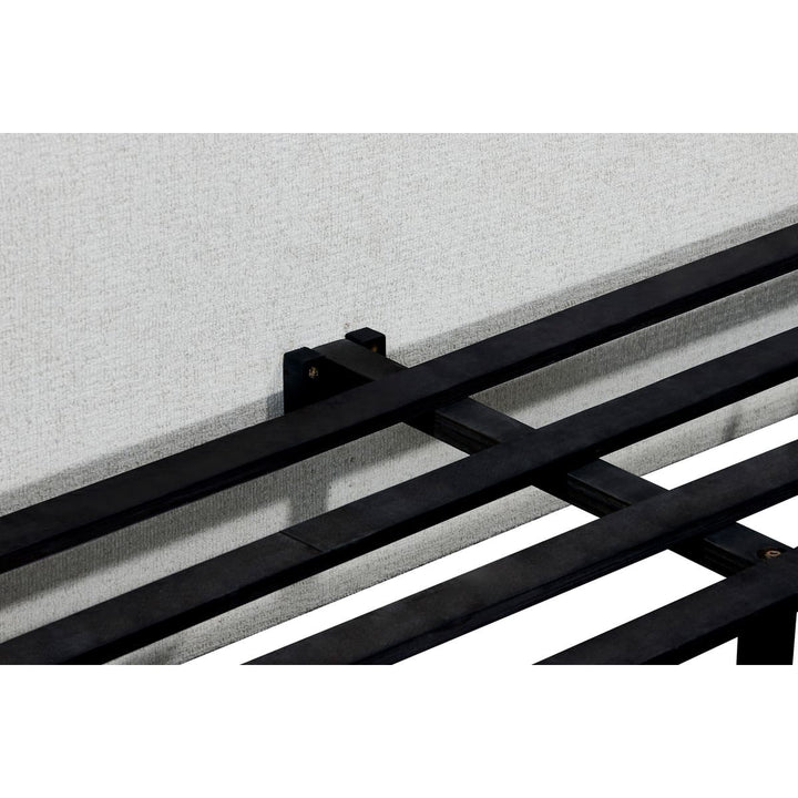 Black metal railing against a light gray wall