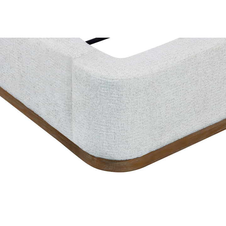 Corner of a mattress with wooden border on a white background